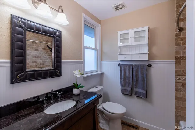 a bathroom with a sink toilet and mirror