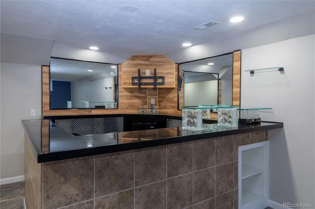 a kitchen with a sink and a mirror