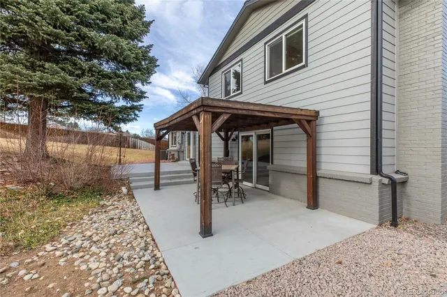 a view of a chairs and table in backyard of the house