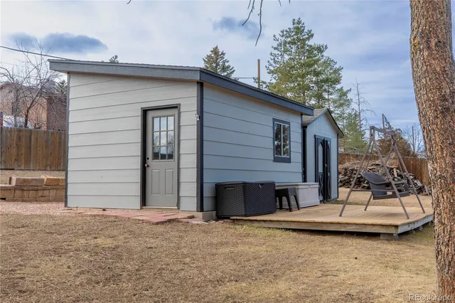 a view of a patio with a table and chairs and potted plants