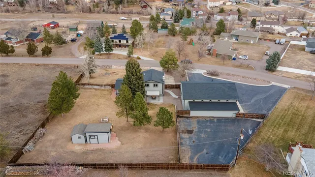 an aerial view of a house with a yard