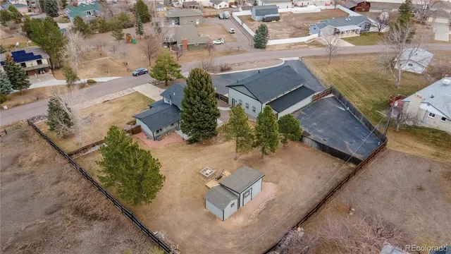 an aerial view of a house with a yard