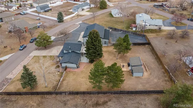 an aerial view of a house with a yard