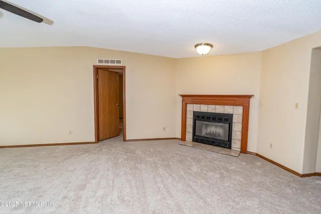 a view of an empty room with a fireplace