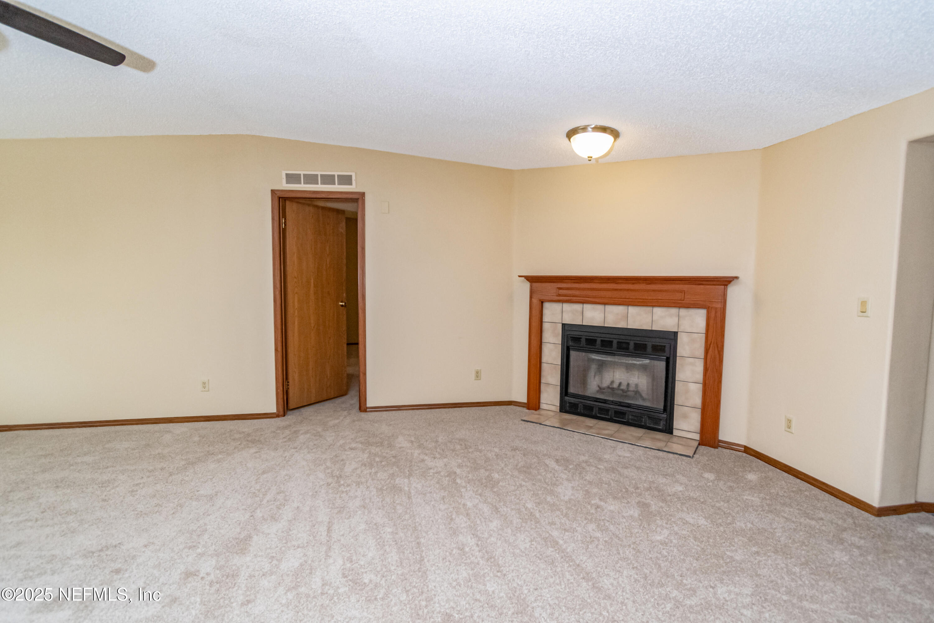 5577 Myrtle Road Macclenny, FL 32063 - Photo 11 of 58 a view of an empty room with a fireplace