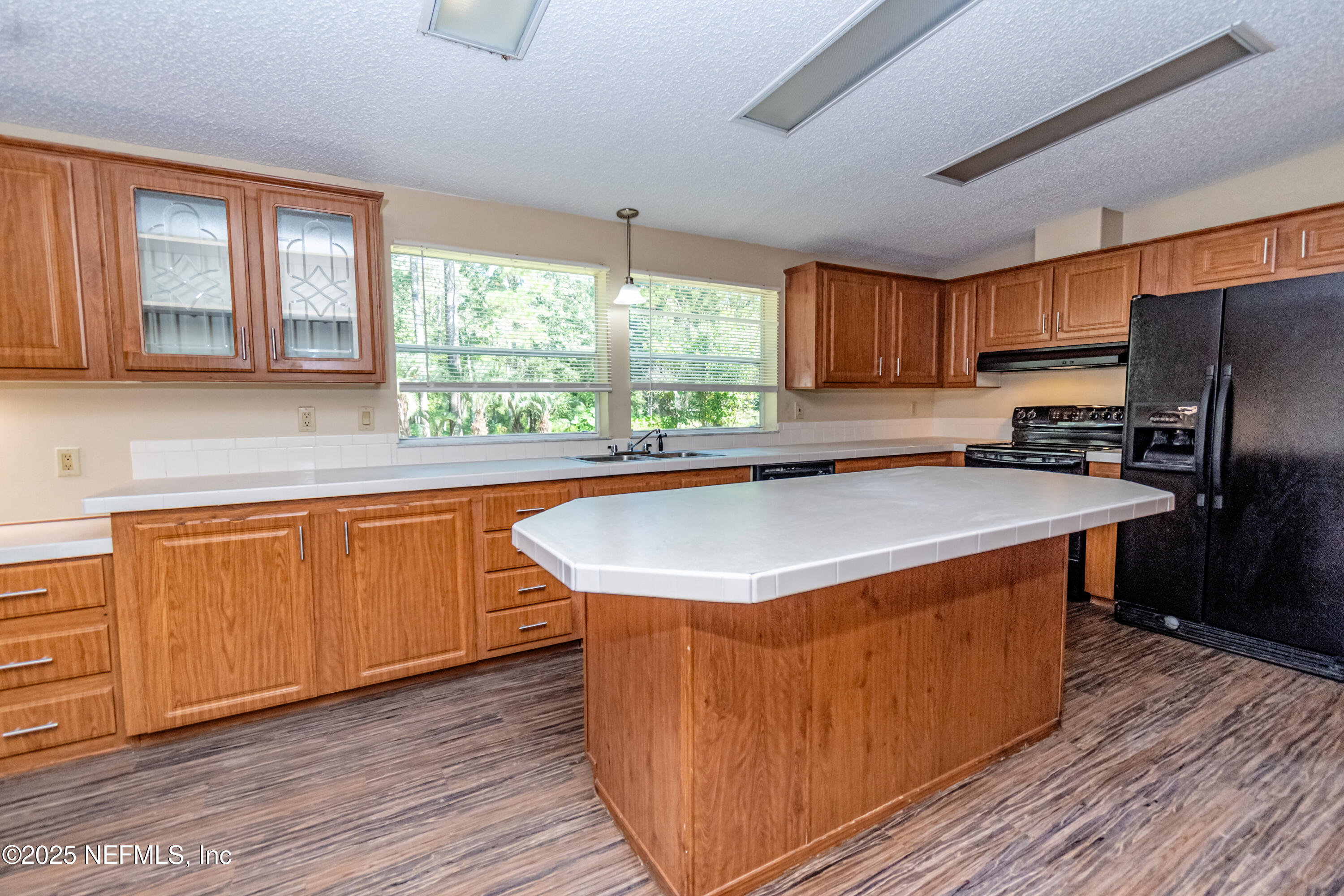 5577 Myrtle Road Macclenny, FL 32063 - Photo 12 of 58 a kitchen with stainless steel appliances granite countertop a sink a stove and a refrigerator