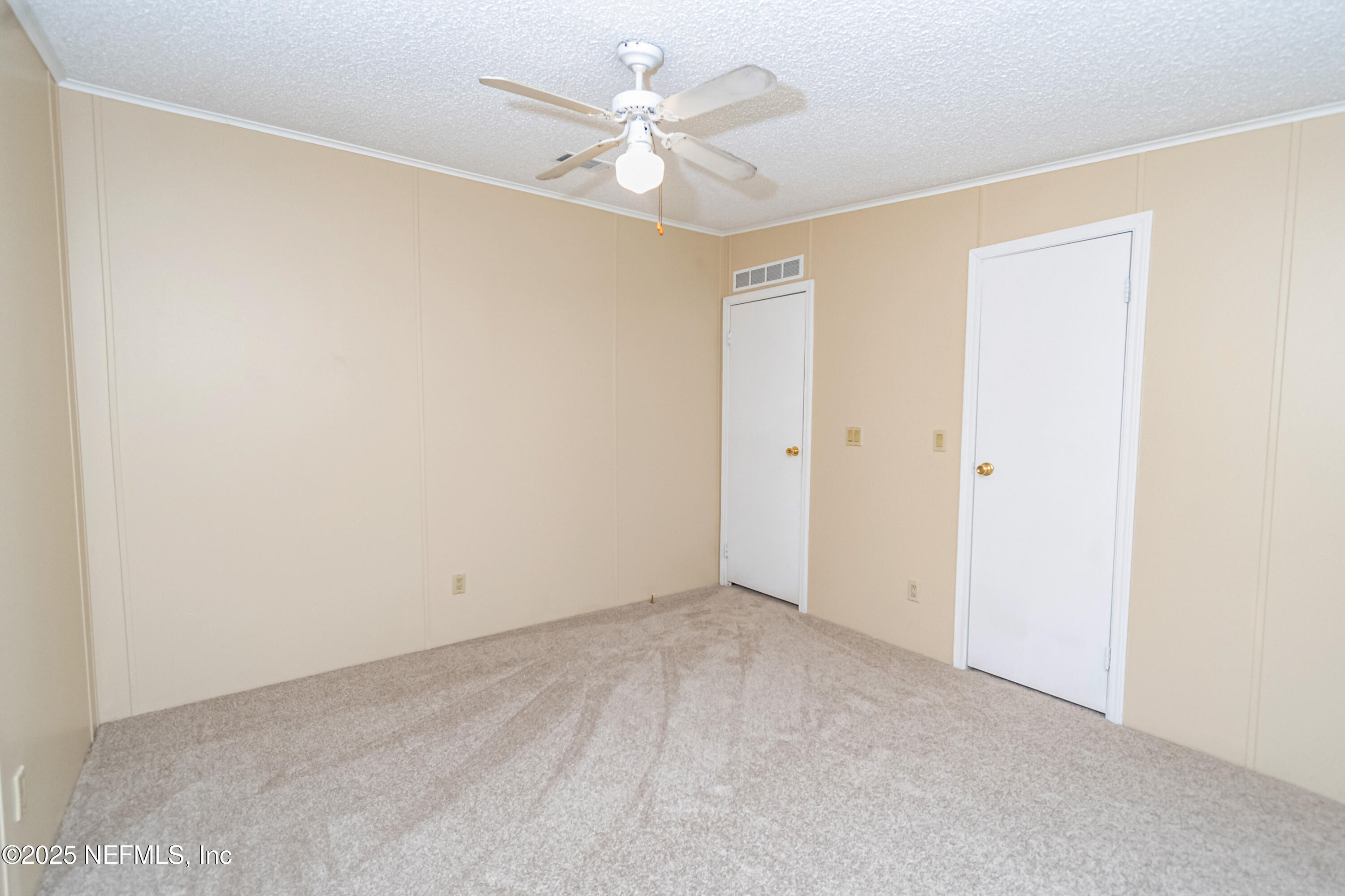 5577 Myrtle Road Macclenny, FL 32063 - Photo 28 of 58 an empty room with a ceiling fan and a window