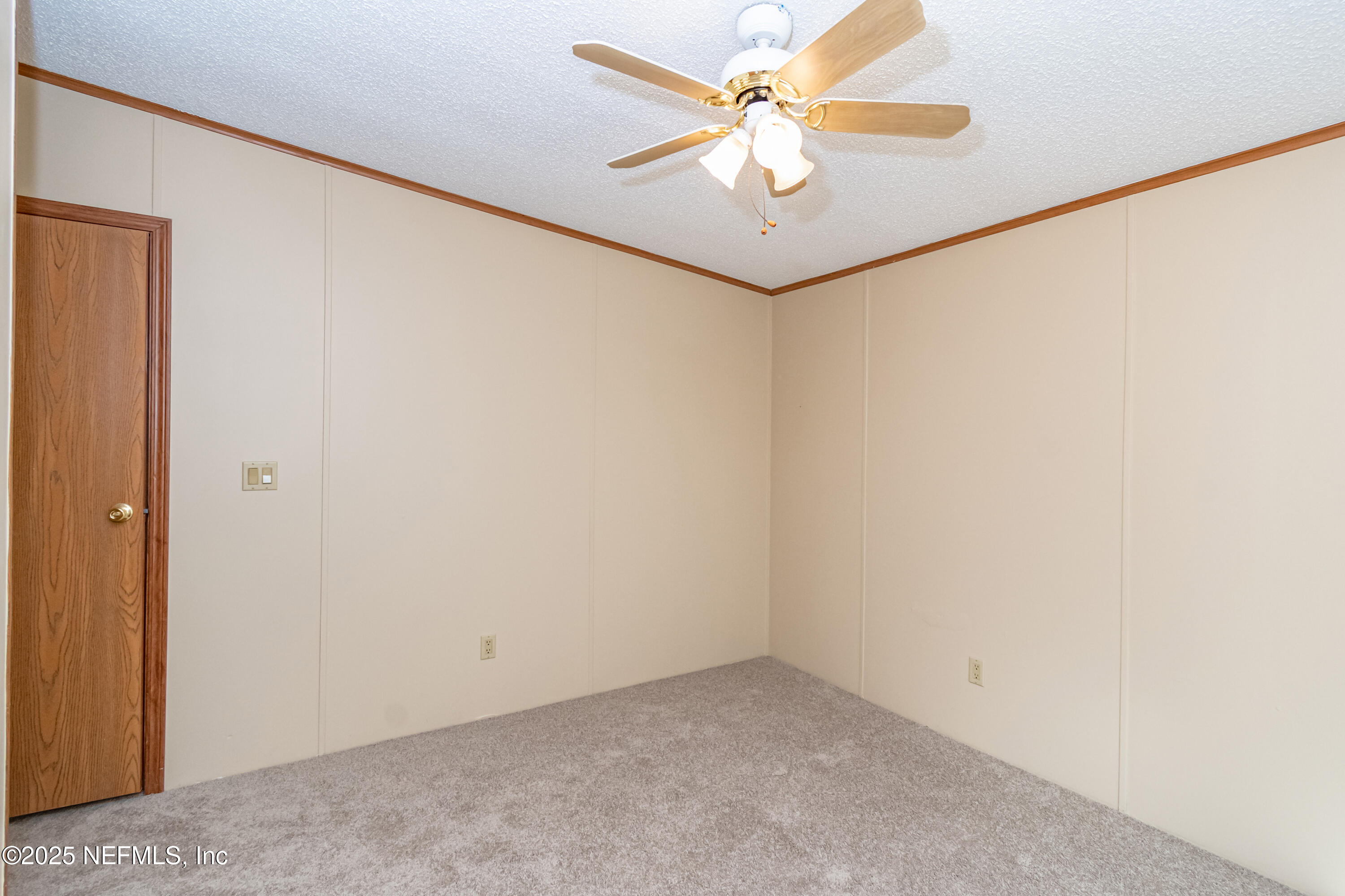 5577 Myrtle Road Macclenny, FL 32063 - Photo 32 of 58 an empty room with a chandelier fan