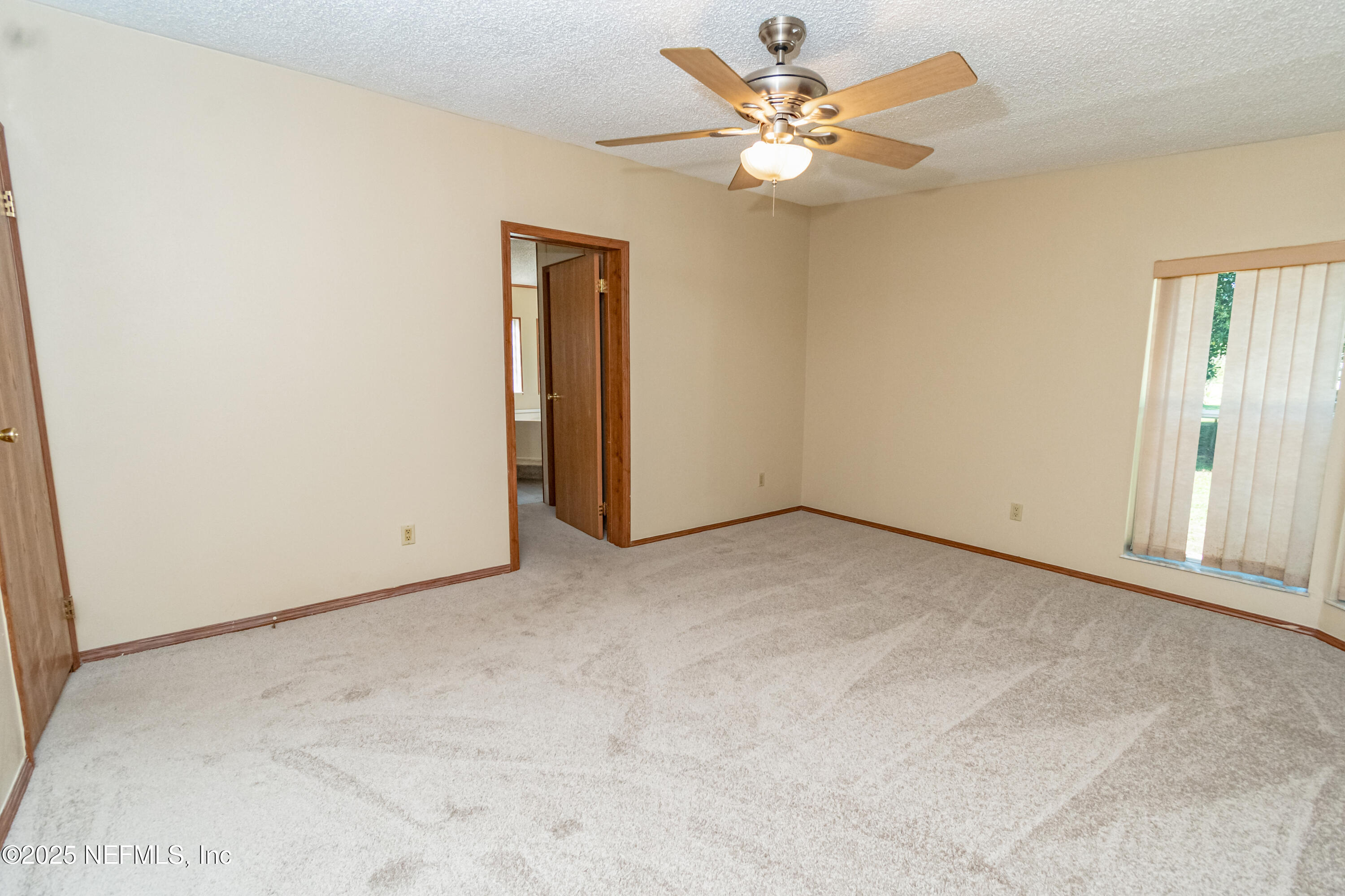 5577 Myrtle Road Macclenny, FL 32063 - Photo 33 of 58 an empty room with a chandelier fan and windows