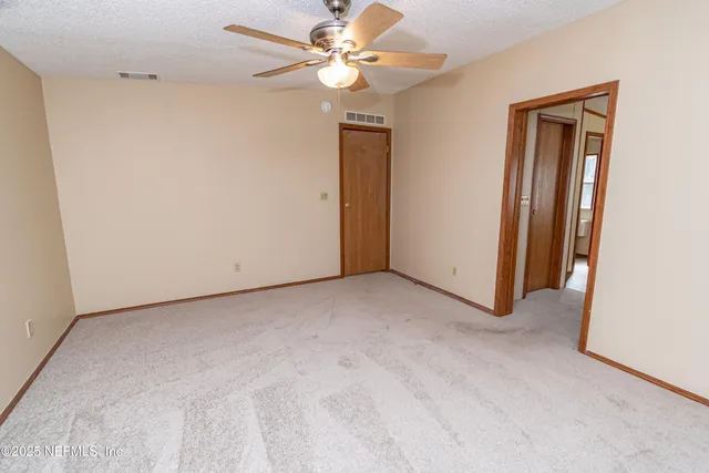 a view of a room with wooden floor and cabinet