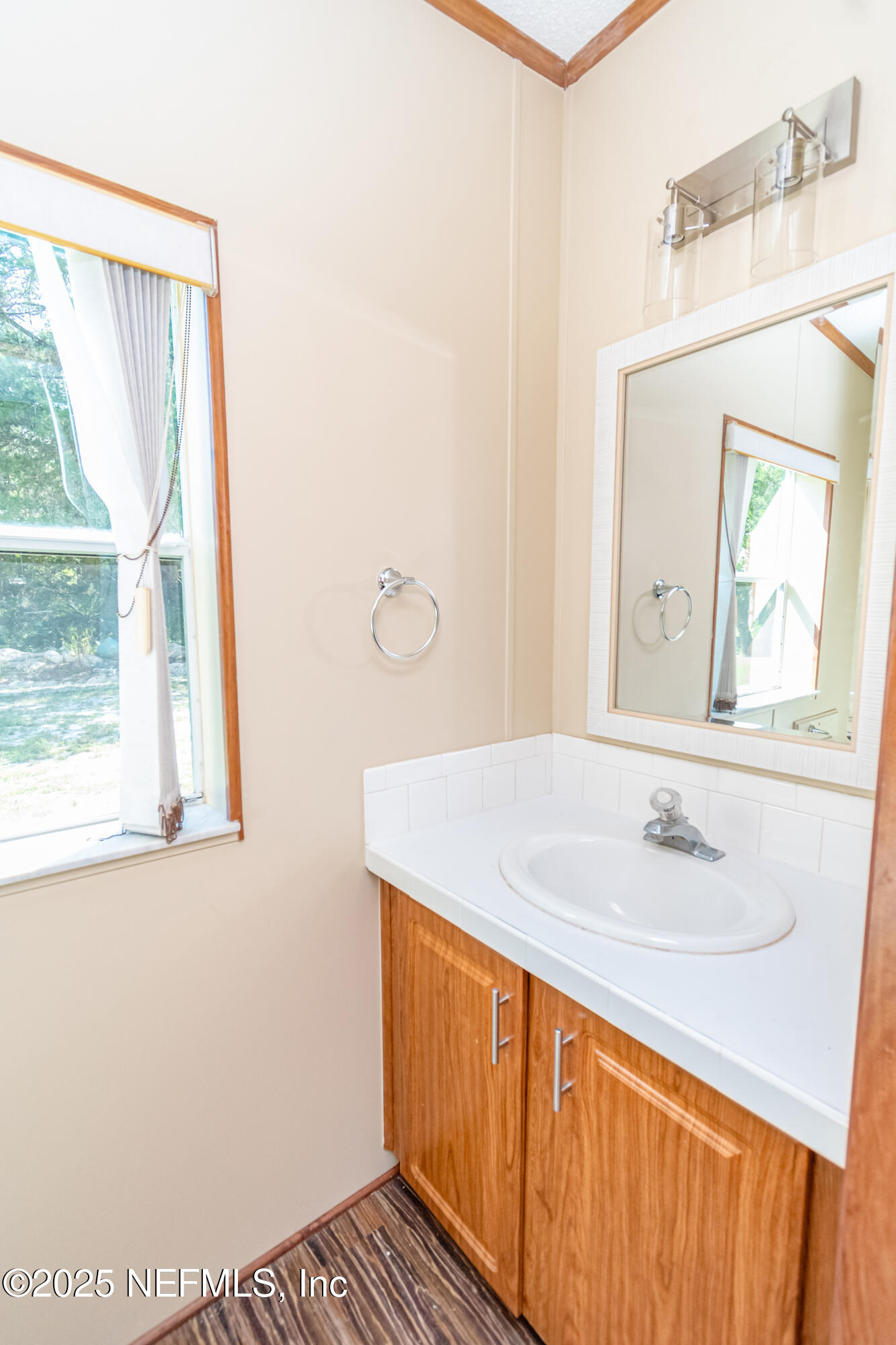 5577 Myrtle Road Macclenny, FL 32063 - Photo 36 of 58 a bathroom with a sink and a mirror