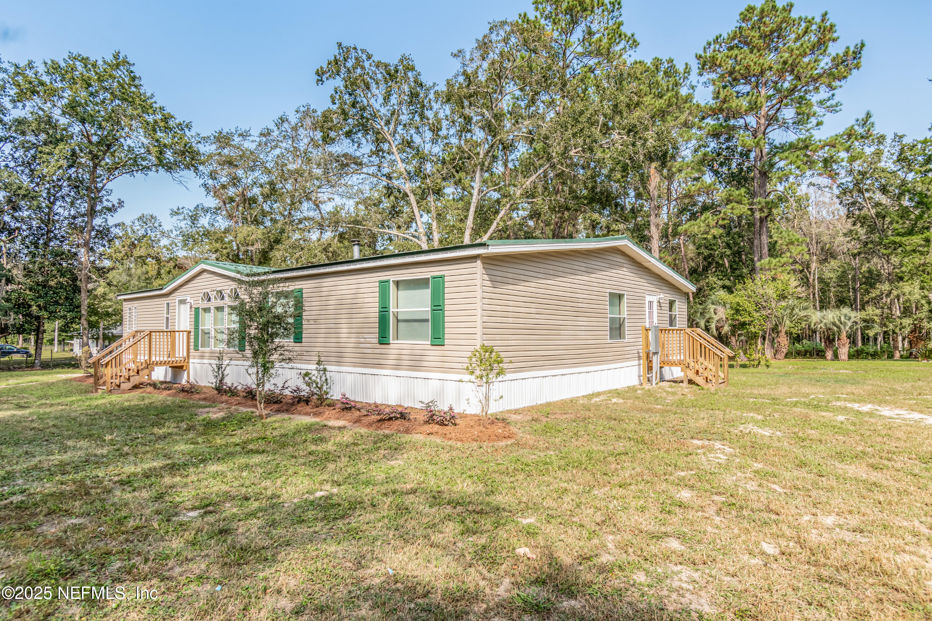 5577 Myrtle Road Macclenny, FL 32063 - Photo 4 of 58 a view of a yard in front of a house with large trees