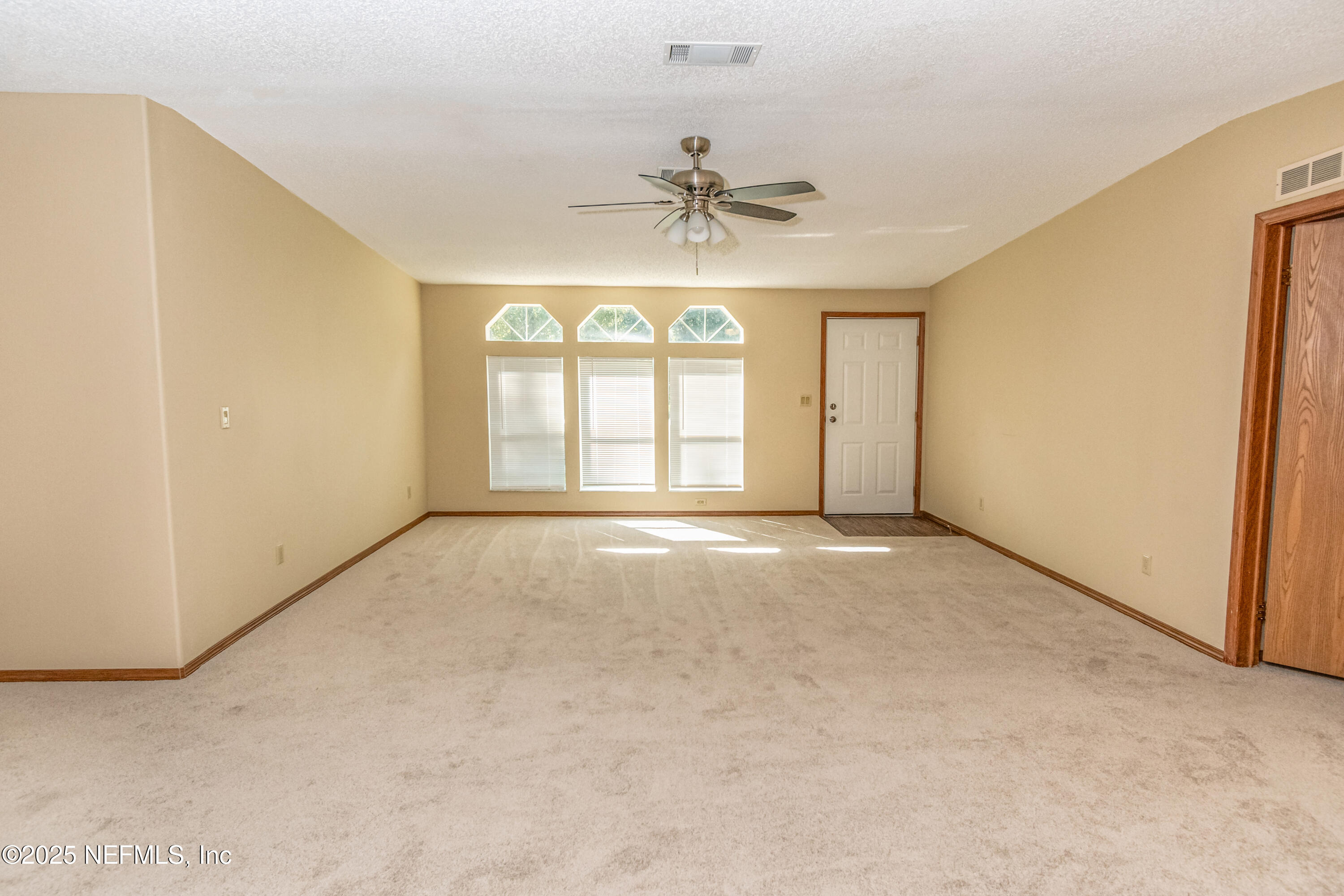 5577 Myrtle Road Macclenny, FL 32063 - Photo 6 of 58 an empty room with windows and ceiling fan