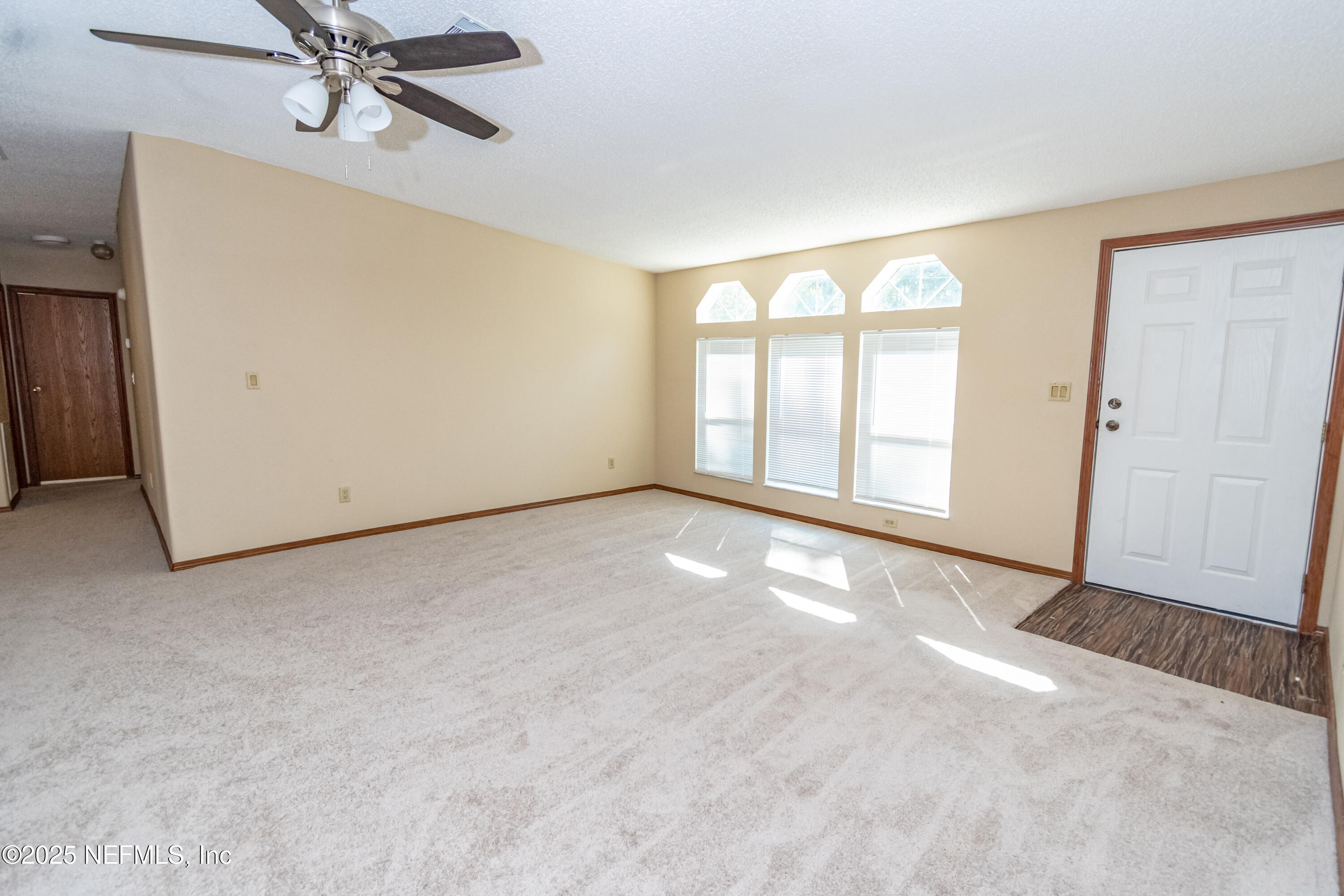 5577 Myrtle Road Macclenny, FL 32063 - Photo 8 of 58 an empty room with windows and fan