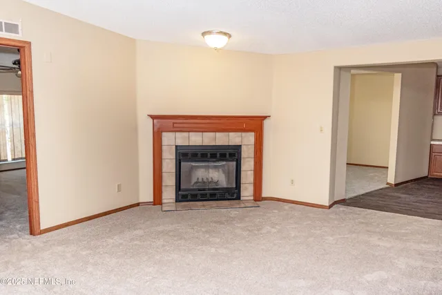 a view of an empty room with a fireplace