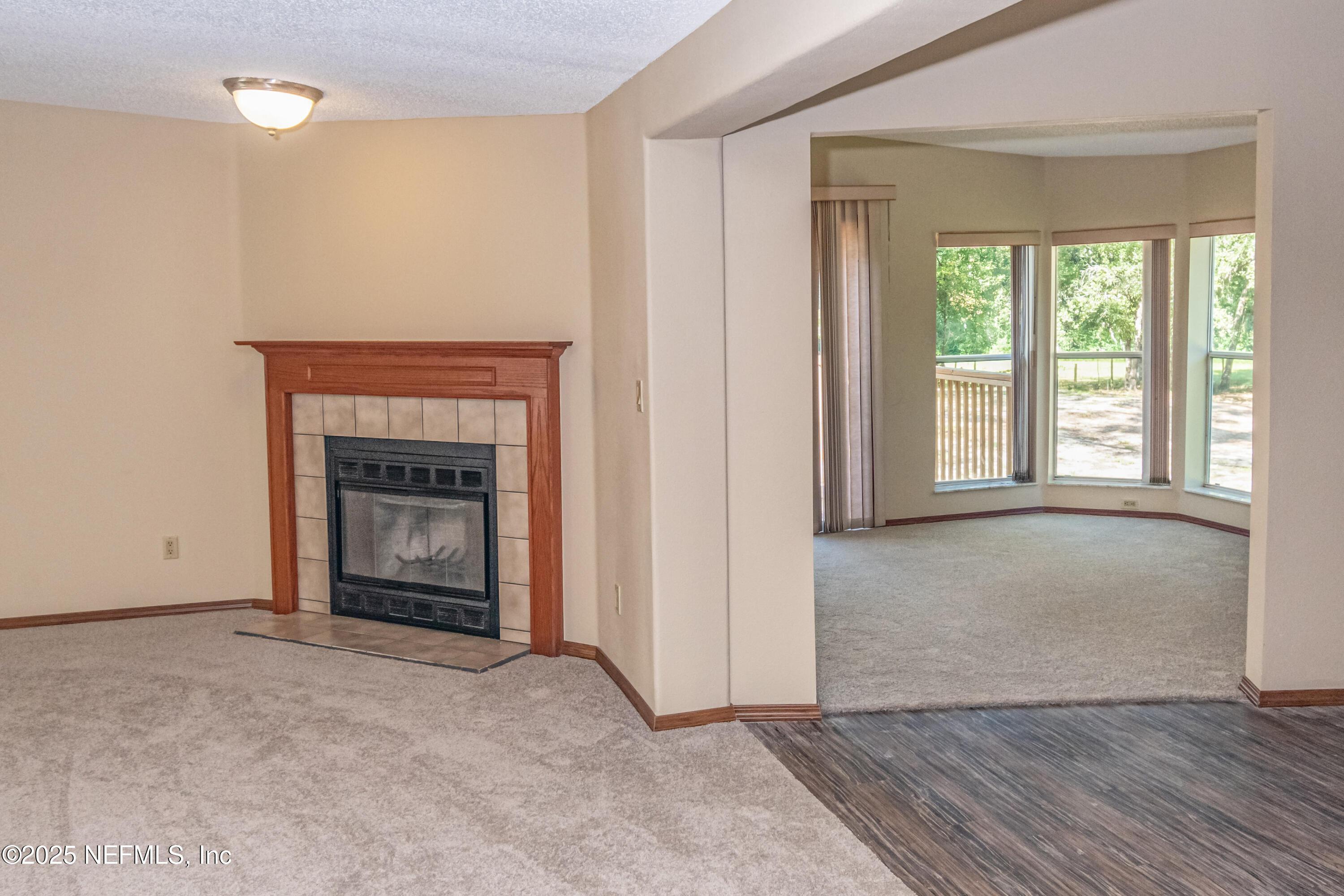 5577 Myrtle Road Macclenny, FL 32063 - Photo 10 of 58 an empty room with windows and fireplace
