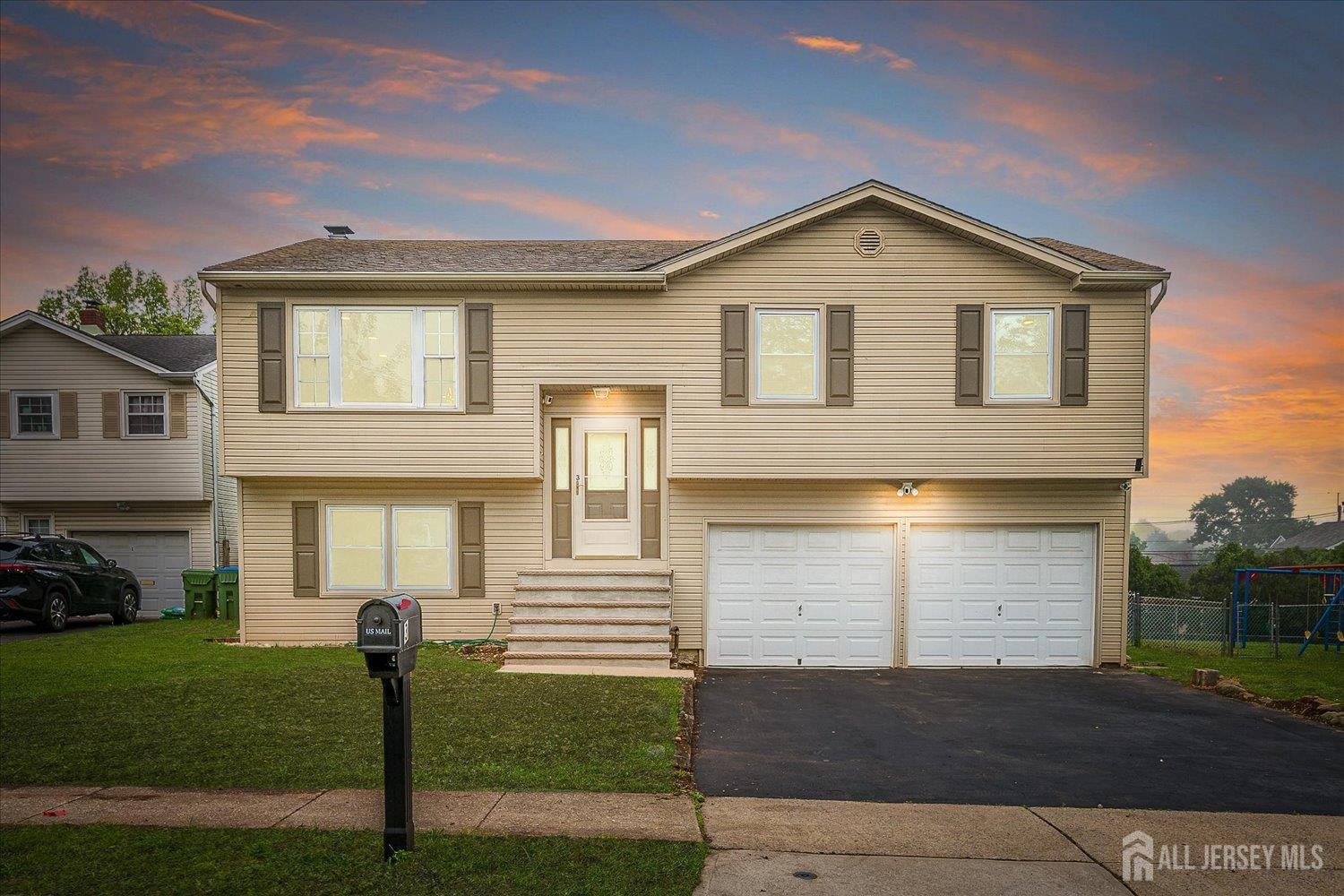 a front view of a house with a garden and yard
