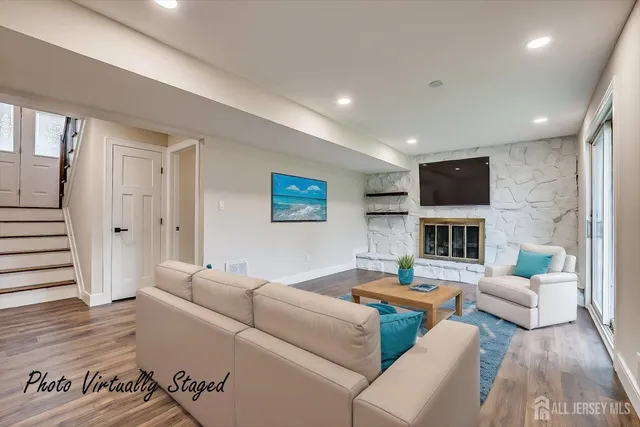 a living room with furniture wooden floor and a fireplace