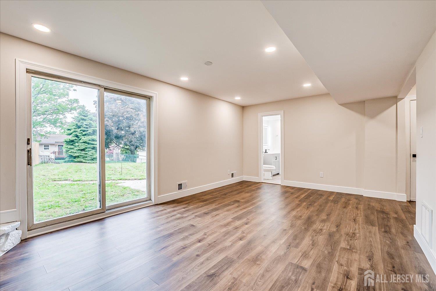 3 Birch Road Edison, NJ 08817 - Photo 26 of 33 a view of an empty room with wooden floor and a window