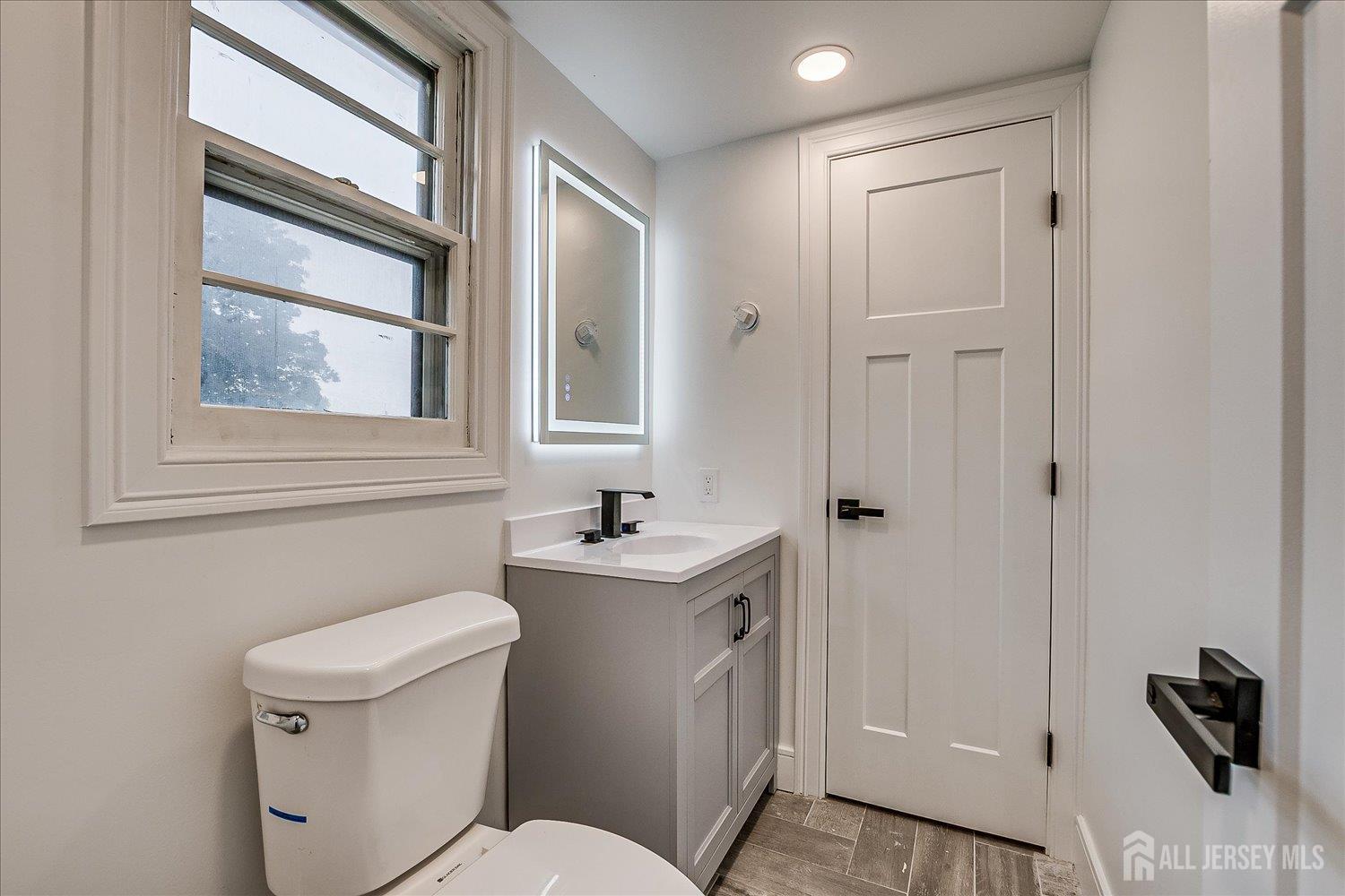3 Birch Road Edison, NJ 08817 - Photo 29 of 33 a bathroom with a toilet a sink and a window
