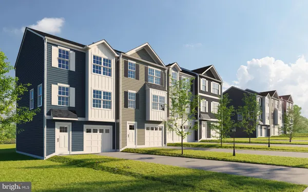 a front view of a residential apartment building with a yard