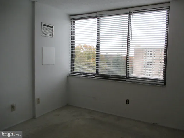 an empty room with a closet and a fireplace