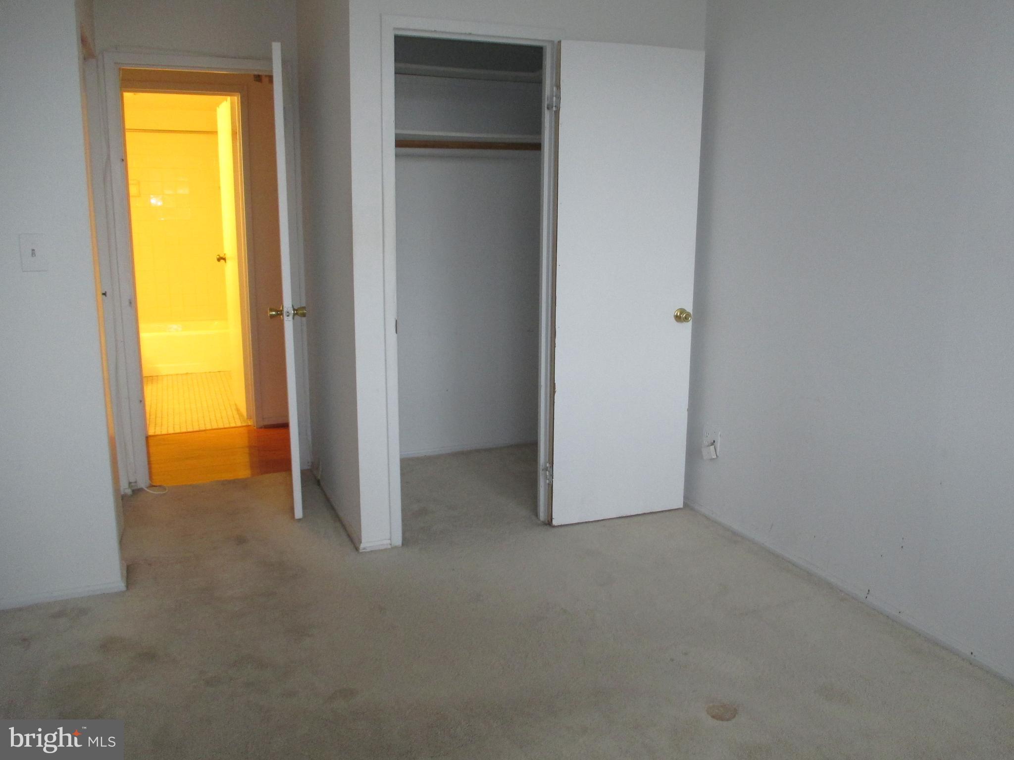 5500 Holmes Run Parkway, Unit 413 Alexandria, VA 22304 - Photo 8 of 8 an empty room with a closet and a fireplace