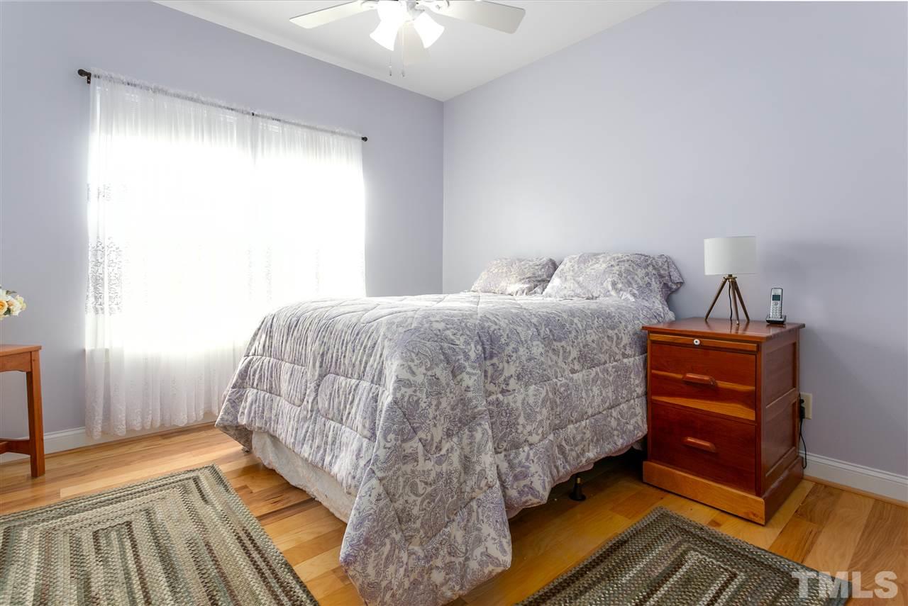 100 North Sunset Ridge Drive Willow Spring, NC 27592 - Photo 11 of 25 a bedroom with a bed and a dresser