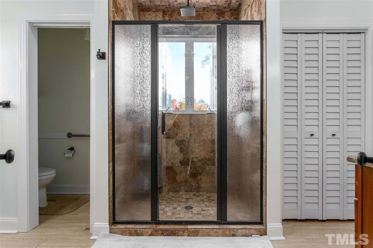 100 North Sunset Ridge Drive Willow Spring, NC 27592 - Photo 16 of 25 a bathroom with a glass shower door