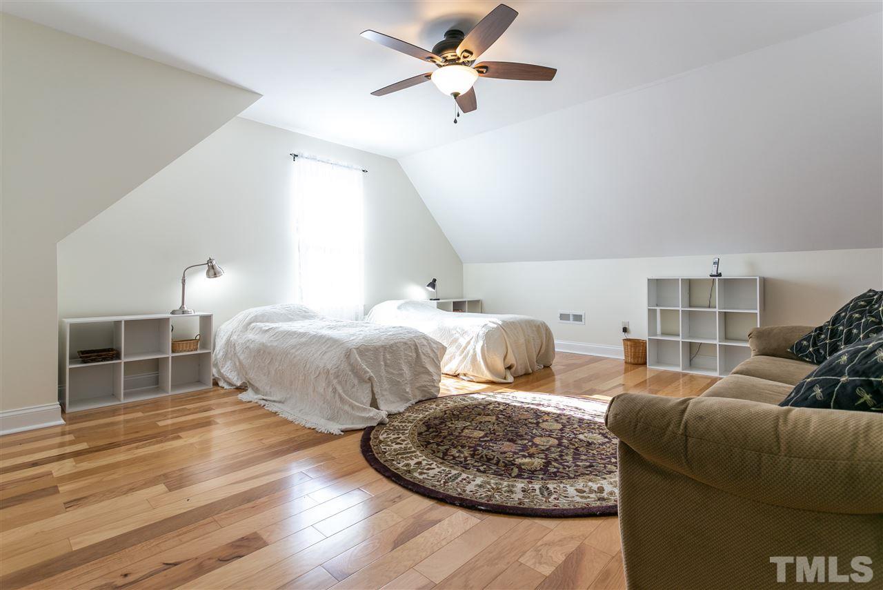 100 North Sunset Ridge Drive Willow Spring, NC 27592 - Photo 17 of 25 a bedroom with two beds and a ceiling fan