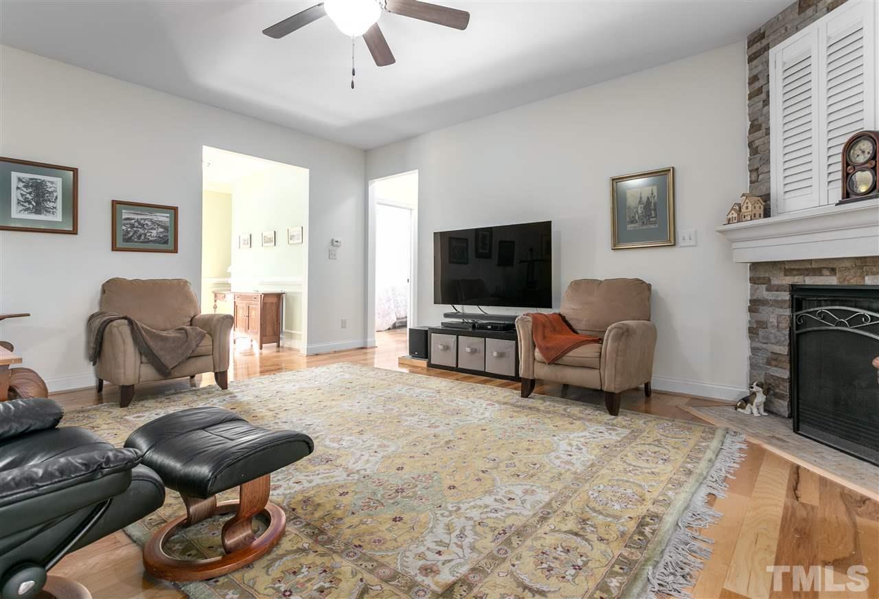 100 North Sunset Ridge Drive Willow Spring, NC 27592 - Photo 10 of 25 a living room with furniture and a flat screen tv
