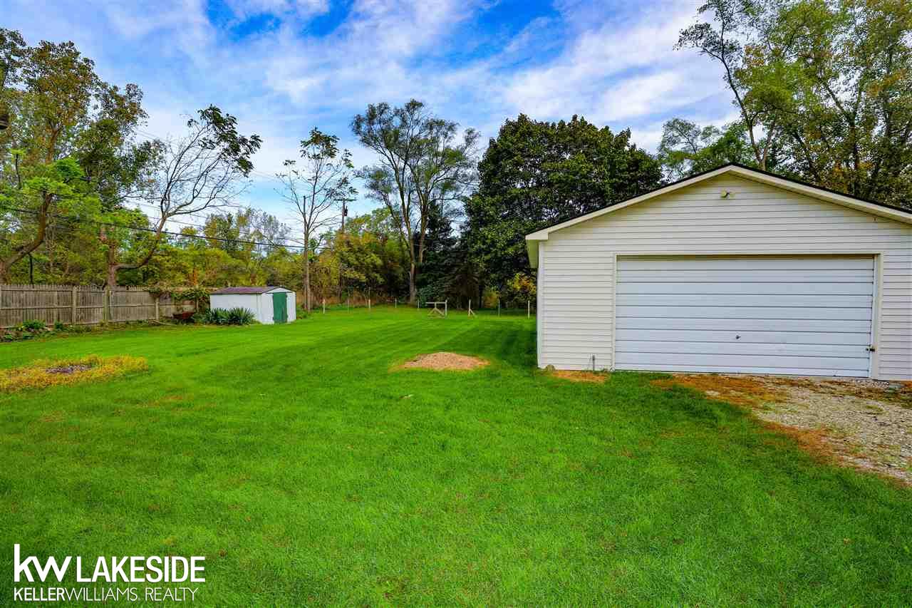 1515 East Hamlin Road Rochester, MI 48307 - Photo 27 of 31 Backyard is perfect for adding a dog run, and the oversized garage is ideal for mechanics, woodworkers or business owner needing to store equipment.