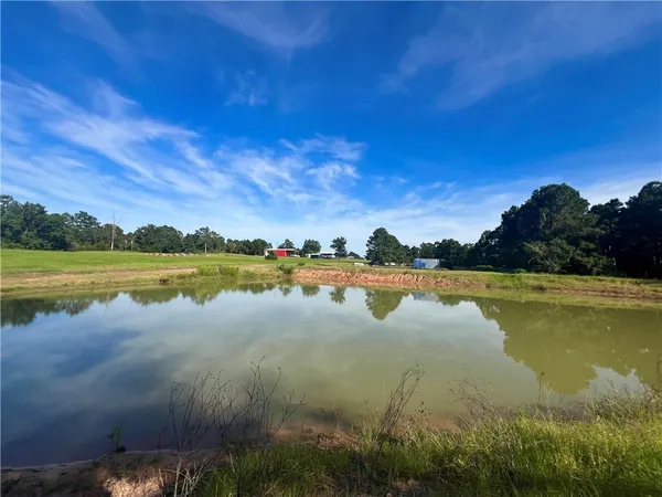 a view of a lake with houses in the back