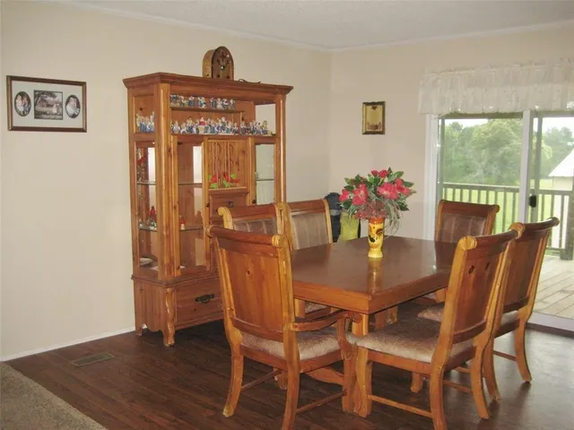 a living room with lots of furniture and a view of kitchen appliances