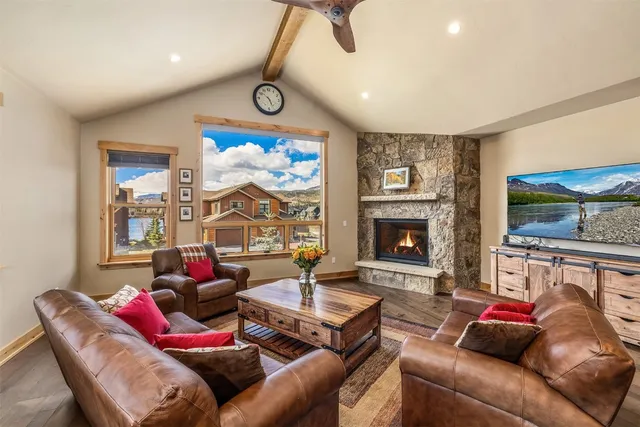 a living room with furniture a flat screen tv and a fireplace