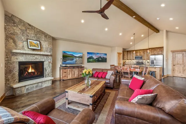 a living room with furniture and kitchen view