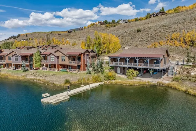 an aerial view of residential houses with outdoor space and swimming pool