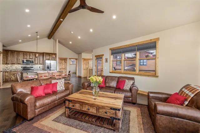 a living room with furniture and a kitchen