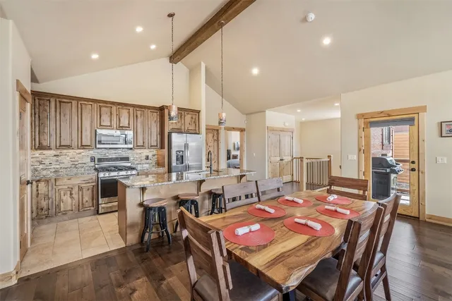 a large kitchen with a table and chairs