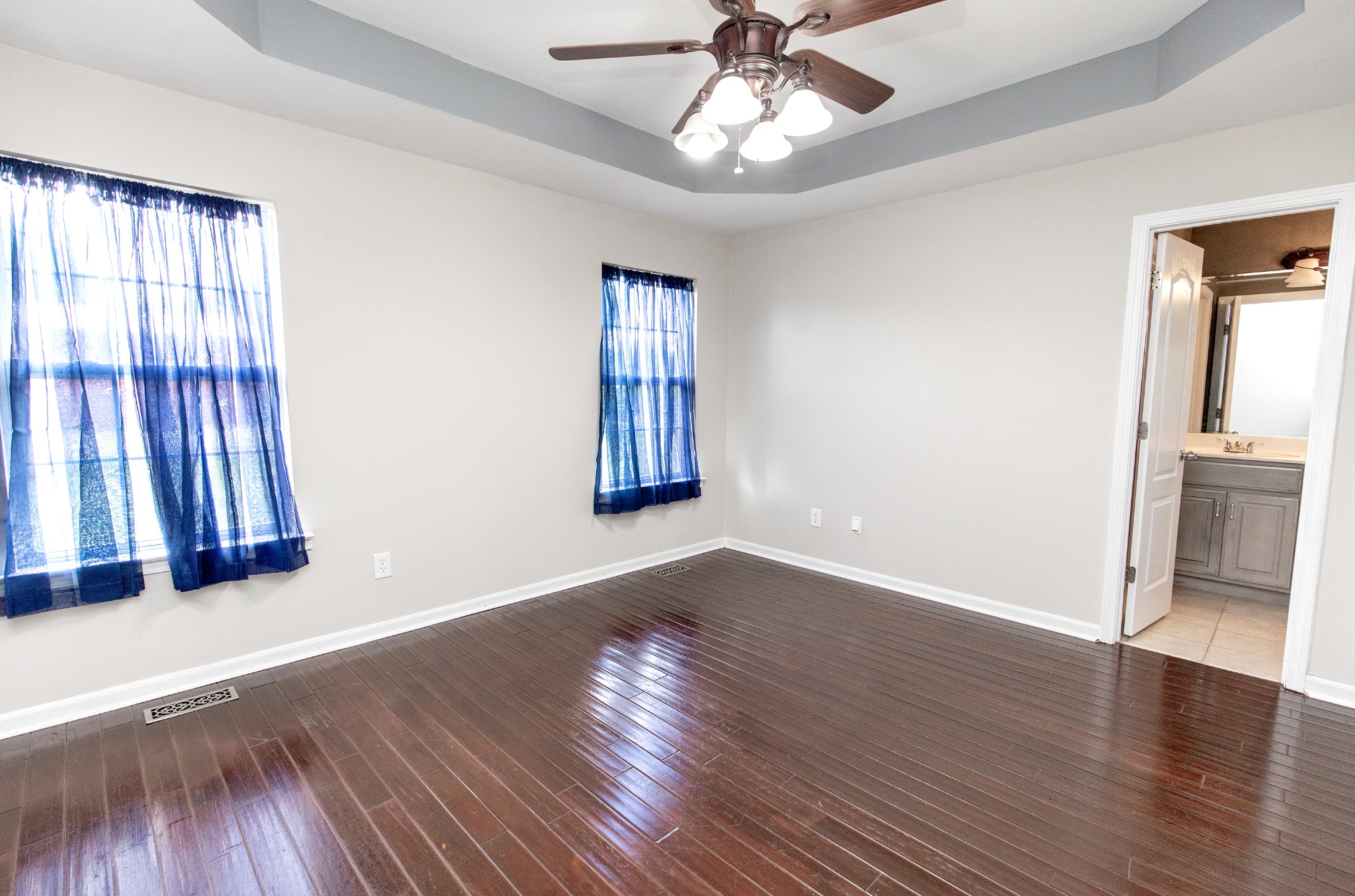 443 Clearview Road Cottontown, TN 37048 - Photo 8 of 21 an empty room with wooden floor fan and windows