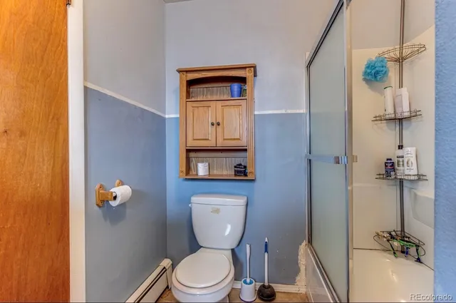 a bathroom with a toilet a sink and mirror