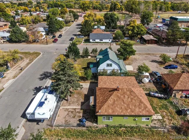 an aerial view of a house with garden space and street view