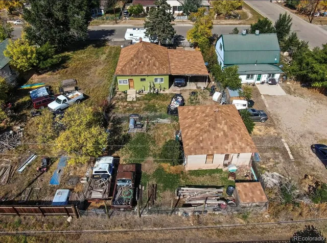 an aerial view of a house with garden space and sitting area