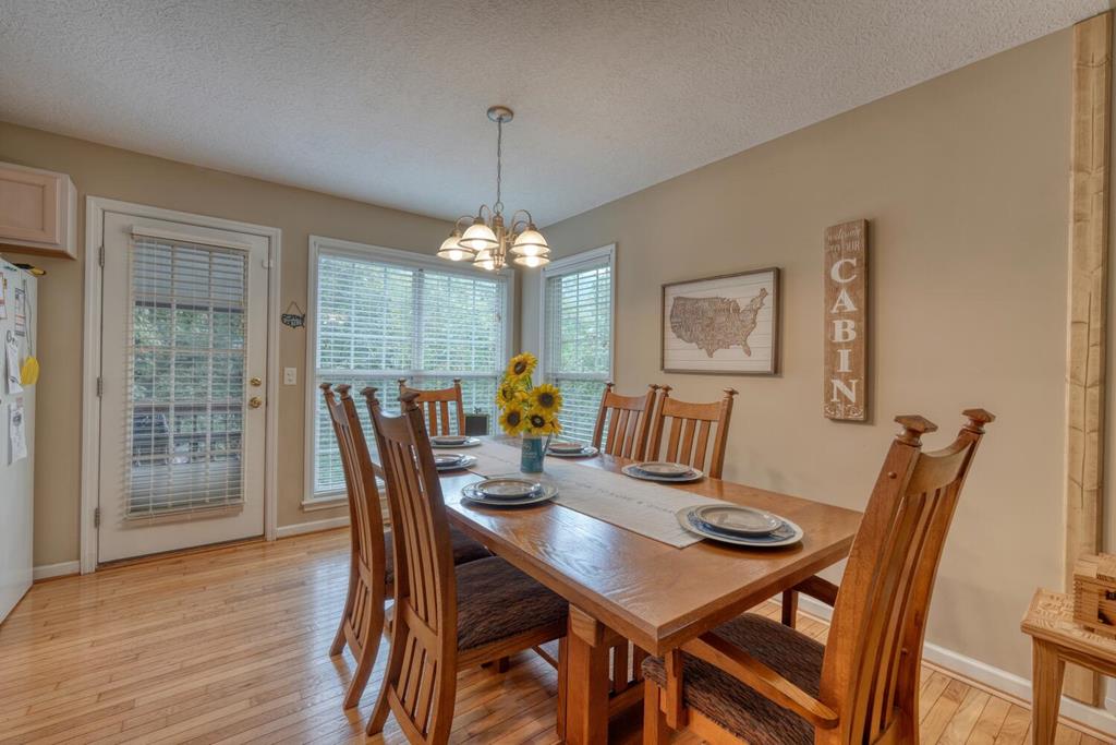 2532 Hunter Road Hiawassee, GA 30546 - Photo 12 of 54 a view of a dining room with furniture window and wooden floor