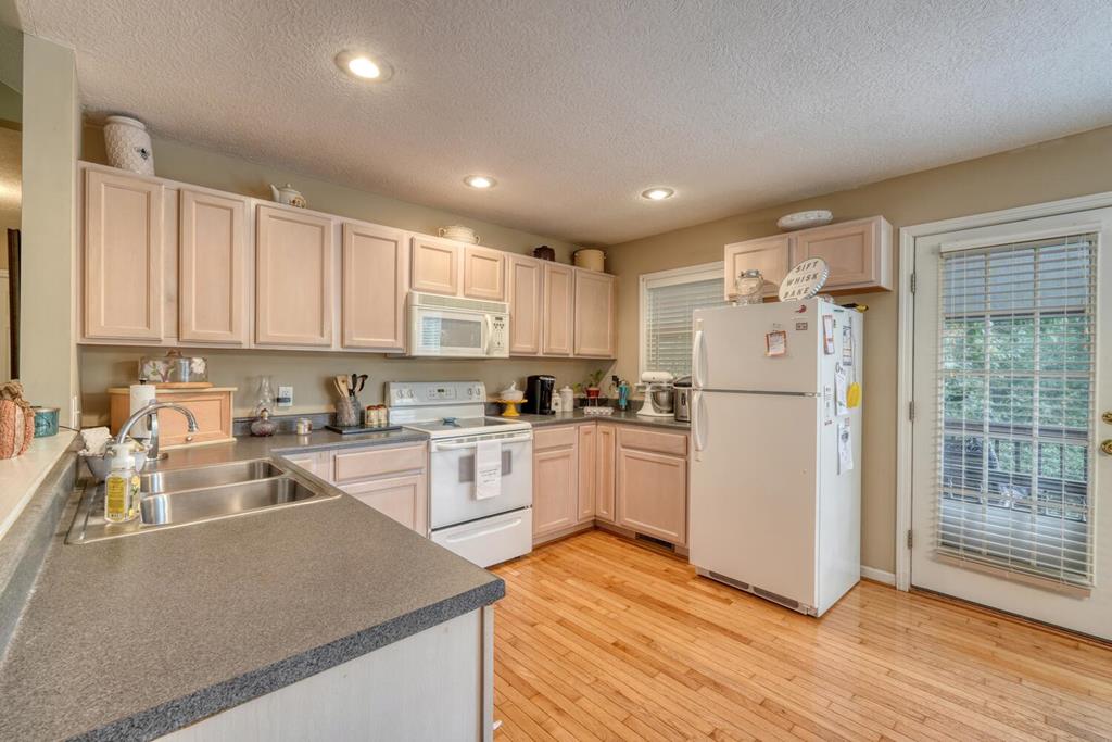 2532 Hunter Road Hiawassee, GA 30546 - Photo 13 of 54 a kitchen with refrigerator cabinets and wooden floor