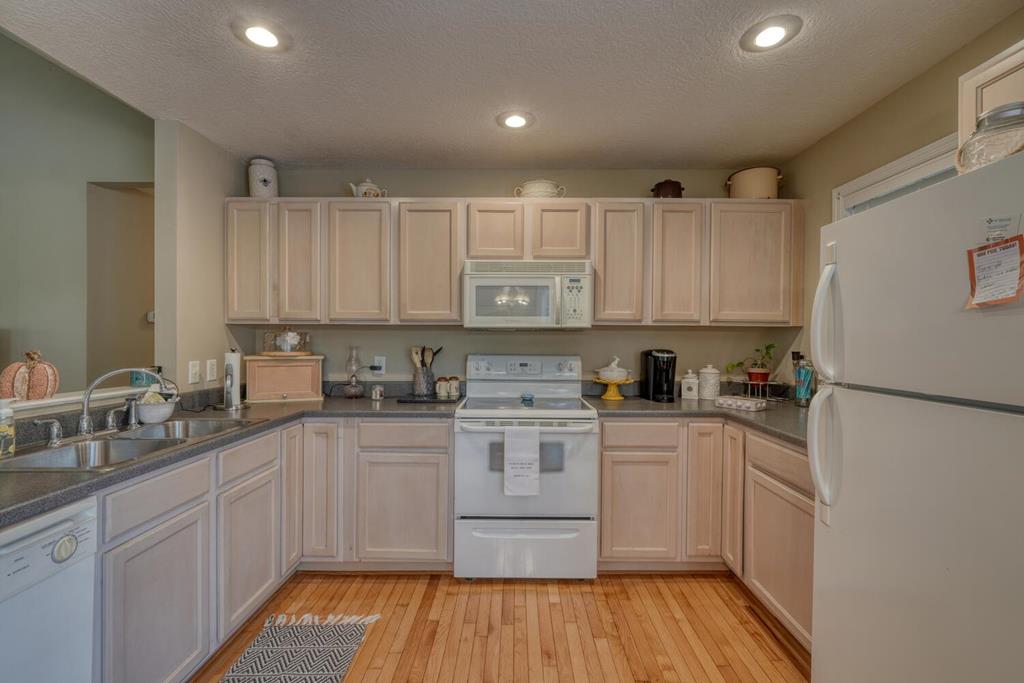2532 Hunter Road Hiawassee, GA 30546 - Photo 14 of 54 a kitchen with a white cabinets sink and white appliances