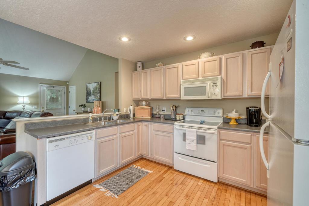 2532 Hunter Road Hiawassee, GA 30546 - Photo 15 of 54 a kitchen with a sink stove cabinets and refrigerator
