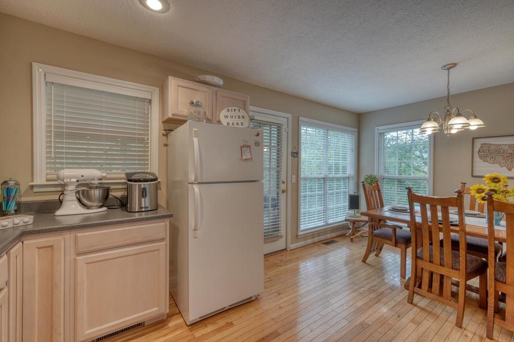 2532 Hunter Road Hiawassee, GA 30546 - Photo 17 of 54 a kitchen with sink refrigerator dining table and chairs