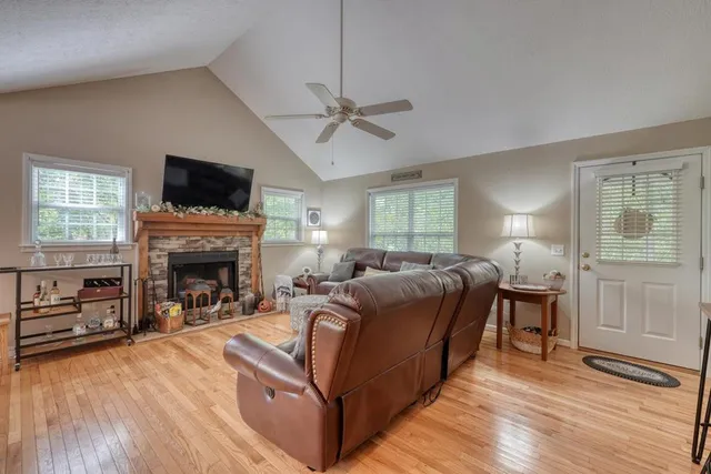 a living room with furniture a fireplace and a flat screen tv
