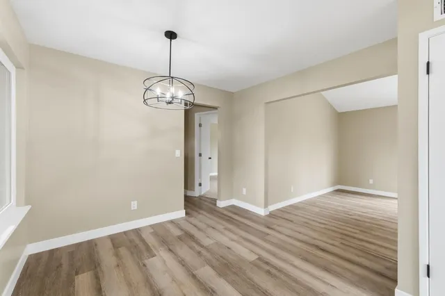 a view of a room with wooden floor fan and window